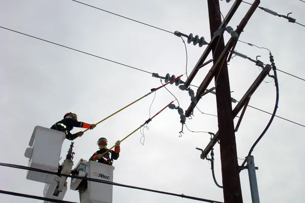 Linemen working on a power pole
